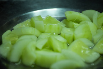 small pies of green cucumber in a bowl