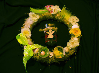 Quail egg. Flowers Easter. Christian holidays. Angel in the center of the wreath.