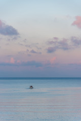 Mirror Still Mediterranean Sea on the Southern Italian Coast at Sunrise with Tiny Fishing Boat