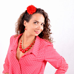 young girl with a red necklace, bracelet, hairpin on a white background.