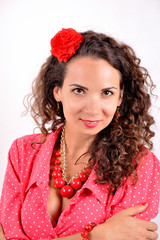 young girl with a red necklace, bracelet, hairpin on a white background.