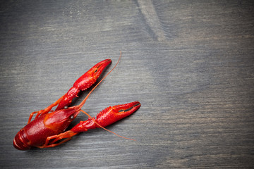 Red cooked lobster on black wooden table
