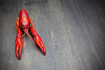 Red cooked lobster on black wooden table
