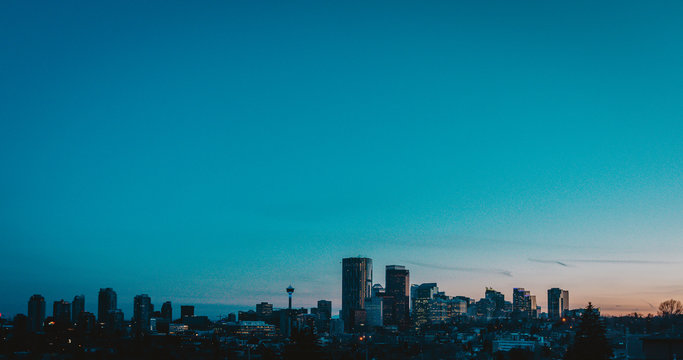 Calgary Skyline In The Late Afternoon With Rays From Setting Sun Reflecting Off Glass Buildings.