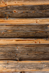 The structure of the wooden log wall, texture of wooden beams