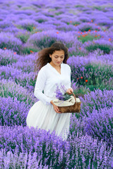 young woman is in the lavender flower field, beautiful summer landscape