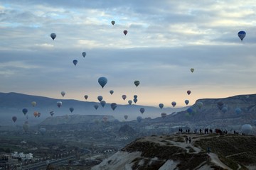 Sunrise and balloons. Beautiful background of the balloon and the sunset.Cappadocia. Turkey. Göreme. Nevşehir. Türkiye. 8. 04. 2019. Balloons flying over the rocky landscape in Cappadocia Turkey. 