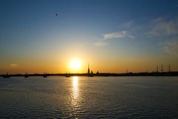 Fototapeta premium sunset over the river, St. Petersburg, view of the city of Peter and Paul Tower and the new tower lahta center.