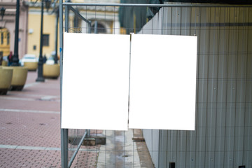poster on a metal fence. advertising poster. clean field to accommodate the design of your sign.