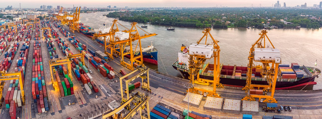 Logistics and transportation of Container Cargo ship and Cargo plane with working crane bridge in shipyard at sunrise, logistic import export and transport industry background