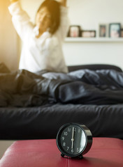 Blured woman stretch lazily in bedroom after waking up in the morning