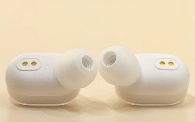Pair white bluetooth earphones.