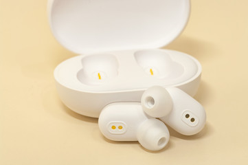 White bluetooth earphones with power box for long time listening music.