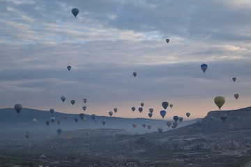 Sunrise and balloons. Beautiful background of the balloon and the sunset.Cappadocia. Turkey. Göreme. Nevşehir. Türkiye. 8. 04. 2019. Balloons flying over the rocky landscape in Cappadocia Turkey. 