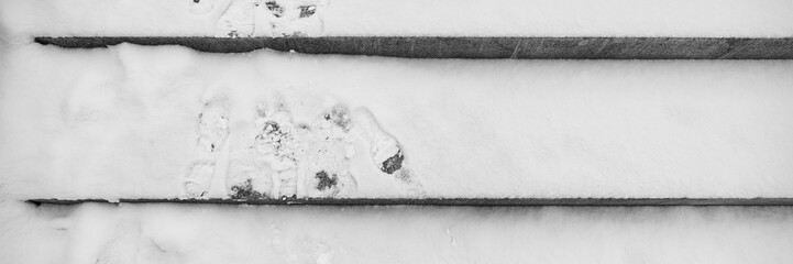 Traces of shoes on the snow on the stairs