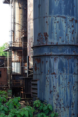 Columns and air shafts with vents, peeling paint over rusted metal, vertical aspect