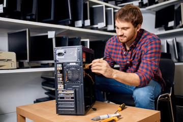 awesome handsome man using a brush to clean a system unit. close up photo, lifestyle, occupation