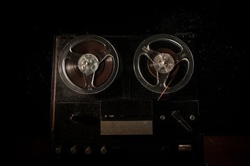 Special agent intelligence officer listens to conversations and records on a reel to reel tape...