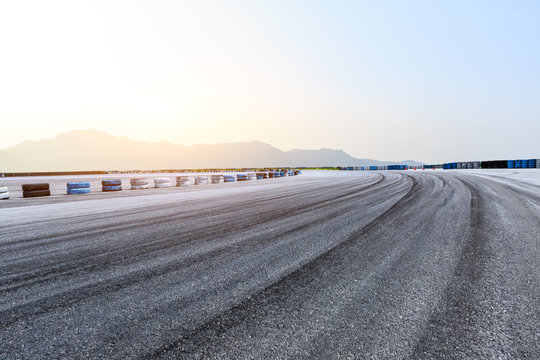 Empty asphalt race track ground and mountains landscape