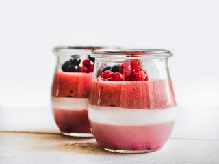 Puff soufflé with ice cream and fresh berries on white boards. Close-up, top view, isolated background. Concept of healthy and delicious food