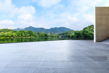 Empty square floor and green mountain with sky landscape
