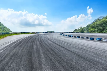 Foto auf Acrylglas Asphalt race track ground and mountains with blue sky landscape © ABCDstock