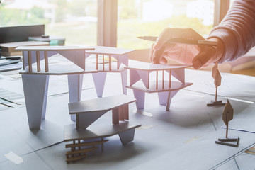 architect design working drawing sketch plans blueprints and making architectural construction model in architect studio