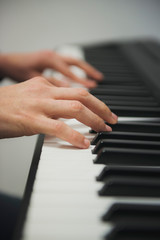 Fototapeta premium hands of a woman playing piano