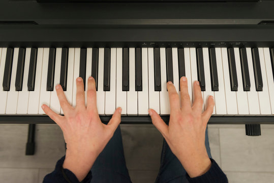 hands of a woman playing piano