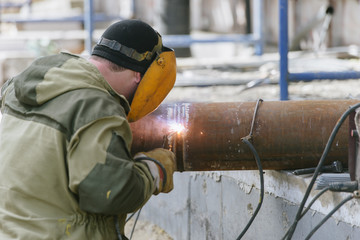 A worker with a welding machine works