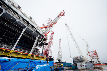 Oil platform under construction and large cranes