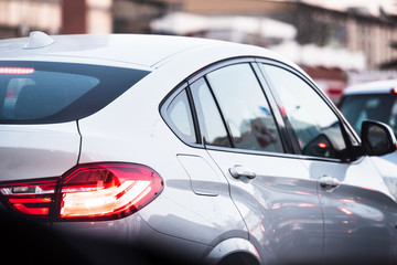 beautiful white luxury car stuck in traffic