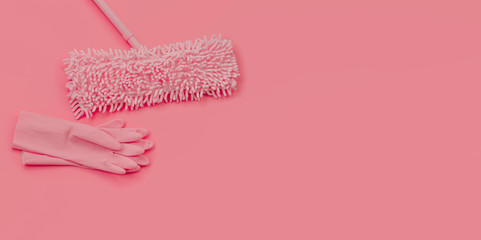 MOP and rubber gloves -pink set on pink background for spring cleaning.  Copy space.