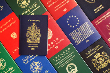 Blue biometric passport of Canada against the background of passports of many countries of the world