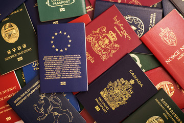 Mixed biometric passports of many countries of the world. In the foreground is a European Union...