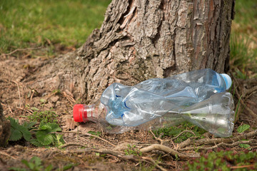 Pollution of plastics on the ground. Plastic waste lies on the ground. Environmental Protection. Plastic bottles and other trash on the ground.