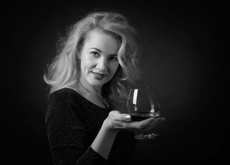  Attractive woman in black evening dress with snifter of brandy