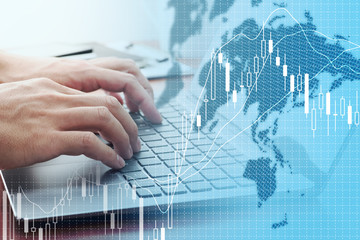 Global stock market concept. Using laptop for stock exchange.World map, candlestick chart and laptop.