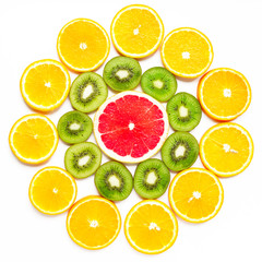 citrus slice, kiwi, oranges and grapefruits in shape of flower on white background. Fruits backdrop