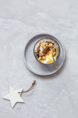 Obraz na płótnie Canvas Granola with yogurt, honey and chocolate bars on marble table with copy space