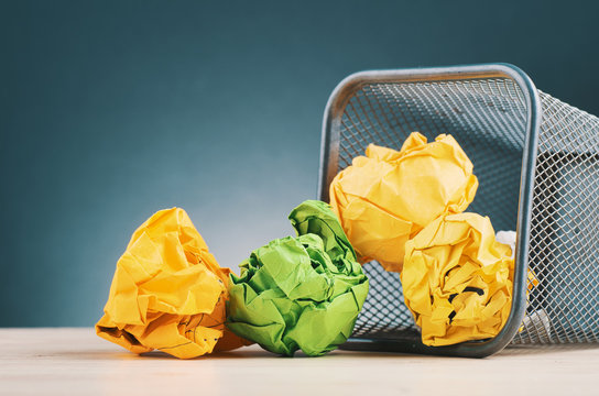crumple paper spilling out from bin for inspiration and innovation concept