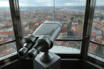 Prague panoramic view from tower above city, in front of view is binocular telescope