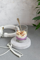 Granola with yogurt, honey and chocolate bars on marble table with copy space