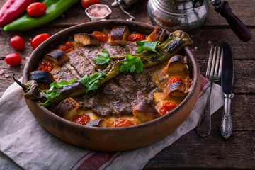 Minced meat kebab in a pot with vegetables and bread