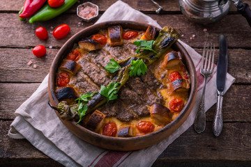 Minced meat kebab in a pot with vegetables and bread