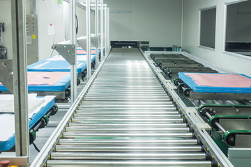 The conveyor chain, and conveyor belt on production line set up in clean room area.