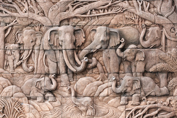 Naklejka premium Elephant carved in stone on the temple wall in Thailand