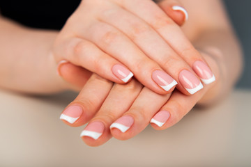 Obraz na płótnie Canvas Beautiful woman's hands with beautiful nails after manicure salon with french manicure