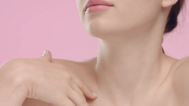Young woman touching her smooth skin in collarbone area