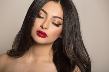 Makeup dark-haired woman. Red lipstick. Fashion and beauty